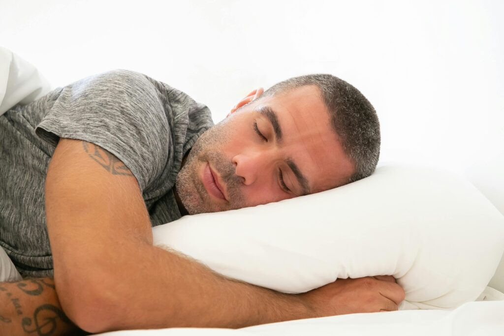 Serene image of a man resting peacefully on a pillow, capturing a moment of calm and relaxation.